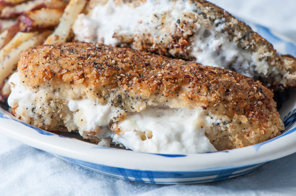 Chicken breaded in all the spices from an everything bagel then stuffed with cream cheese creates the ultimate indulgence. Use that extra seasoning for some baked french fries and you have an entire meal with this Cream Cheese Stuffed Everything Chicken with Everything Fries. Yum!