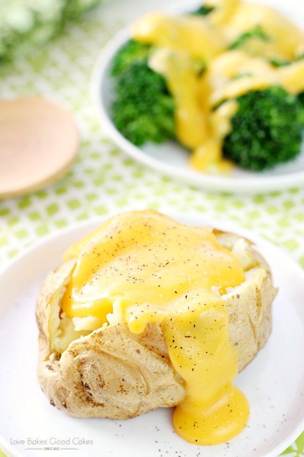 Basic Cheese Sauce over a baked potato and broccoli on plates. 