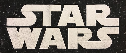 Star Wars Logo paper pieced 10" x 24" quilt block designed for fandominstitches.com's #starwarsquiltchallenge