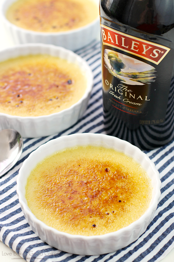Irish Cream Crème Brûlée in white bowls with a bottle of Baileys.