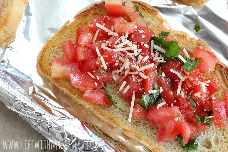 This fresh tomato bruschetta recipe is made on freshly baked sourdough bread and is topped with a tomato basil mix and Parmesan cheese! It's the perfect appetizer or side dish for any Italian meal! And it's DELICIOUS!