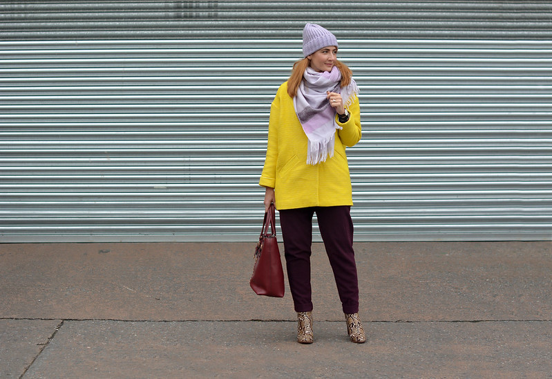 Bright winter outfit | Yellow coat, purple trousers, lilac scarf & hat, snakeskin boots