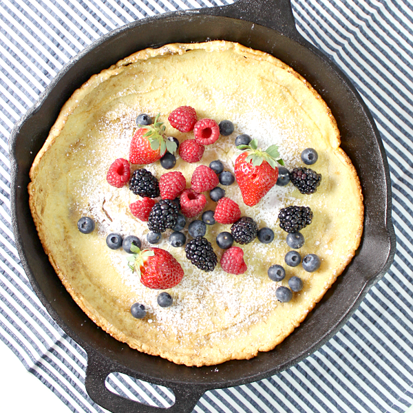 Dutch Baby Pancake with Fresh Berries in a skillet looking down.