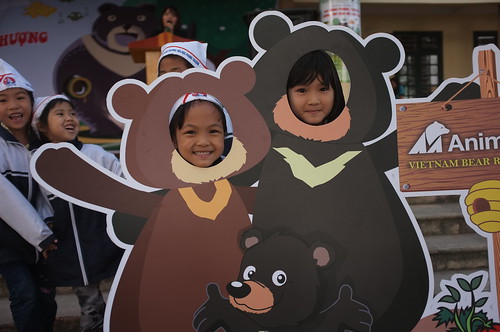 Kids excitedly pose with the bear photo booth