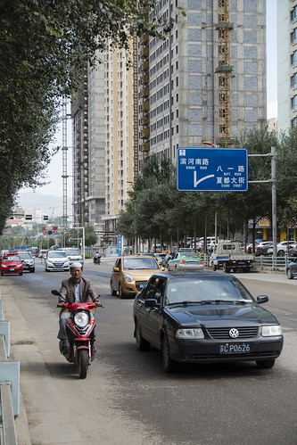 china road street urban building cars sign asia cityscape motorbike qinghai xining chn sonyrx100iii