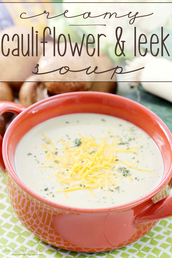 Creamy Cauliflower & Leek Soup in a red bowl with cheese.