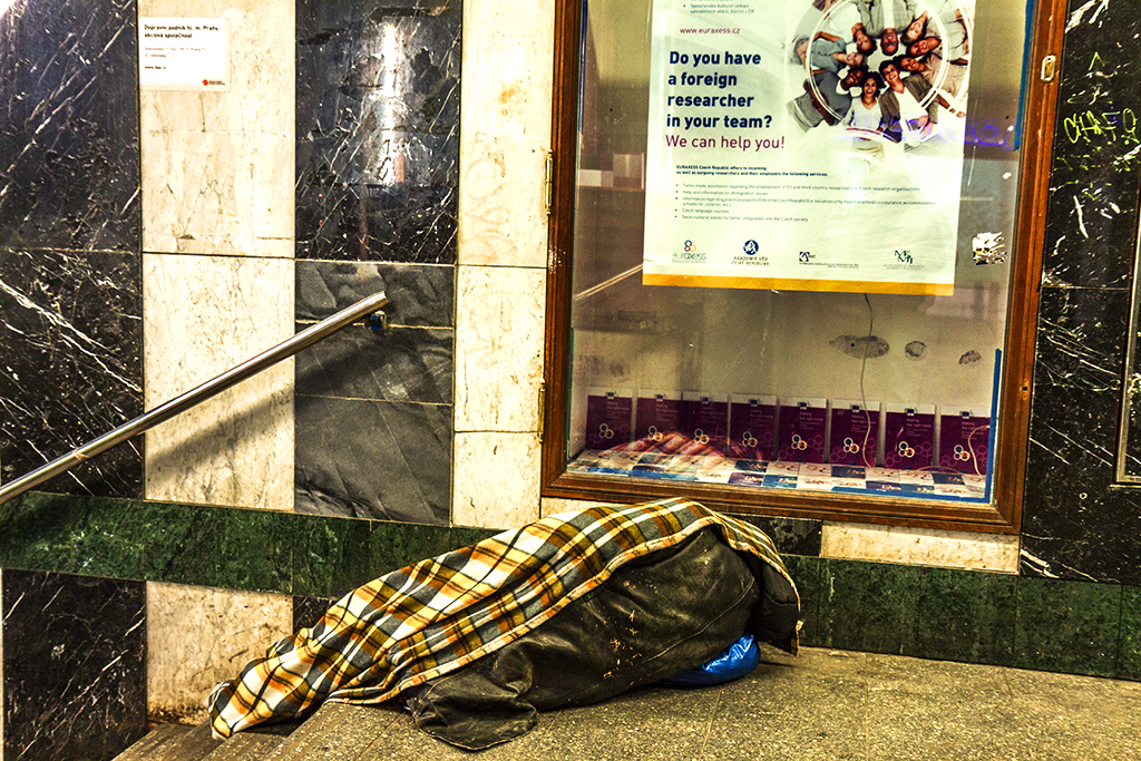Woman sleeping at Mustek subway entrance--Prague