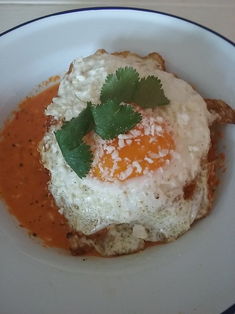 Crispy hash brown chilaquiles with sunny-side up egg, cotija and salsa macho