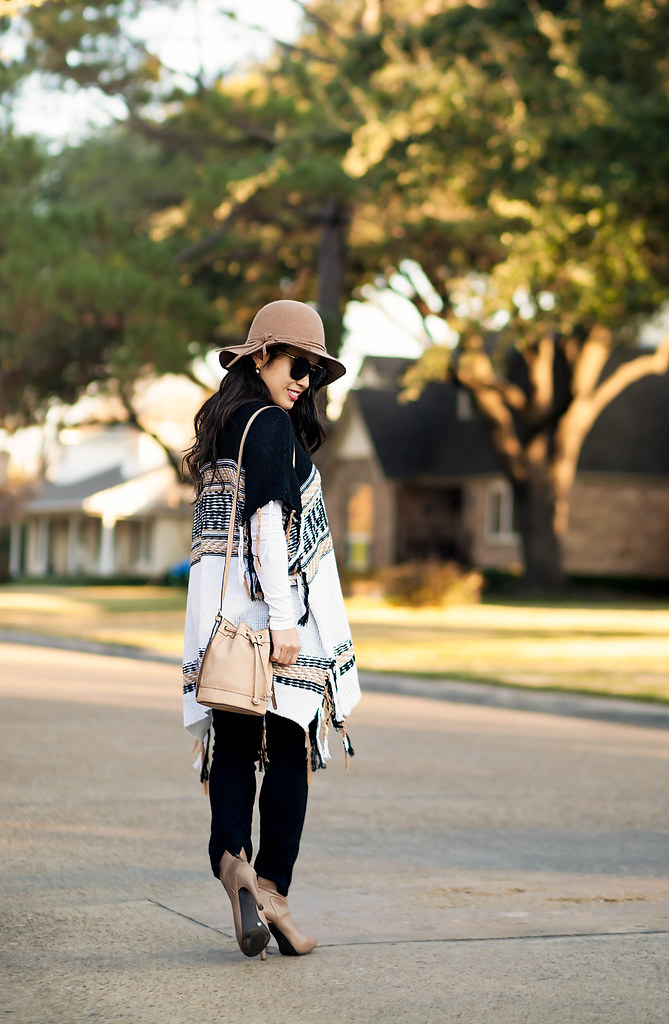 cute & little blog | petite fashion | free people labyrinth poncho, black jeans, taupe ankle boots, boho bucket bag, felt floppy hat | fall winter outfit