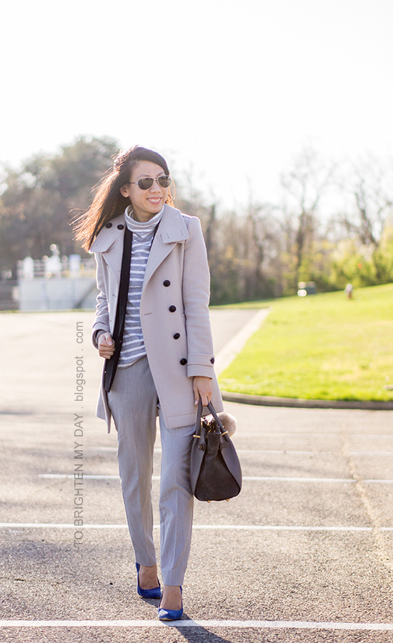 gray wool trench coat, gray turtleneck, black vest, gray trousers, blue suede pumps, gray tote with faux fur keychain