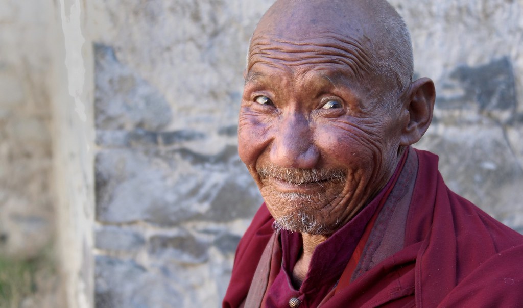 Monk of Tashi Lhunpo monastery make us laugh by pulling funny faces, Tibet 2015