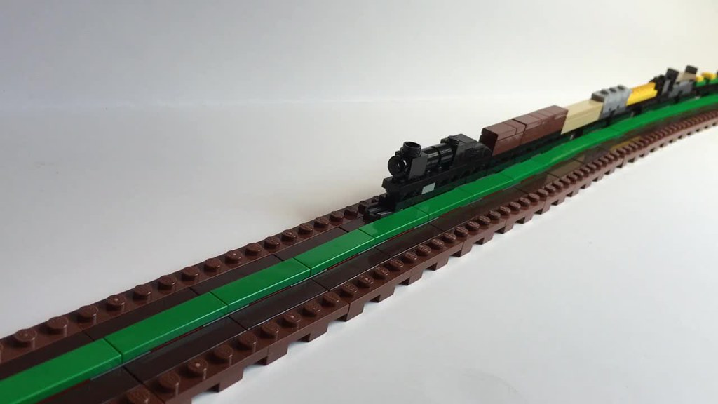 One stud wide trains: articulated magnetic coupling, flexible magnetic track, and track switch.