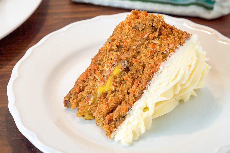 slice of carrot cake with orange curd and cream cheese frosting