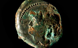 Bronze coin of Minerva found in tomb