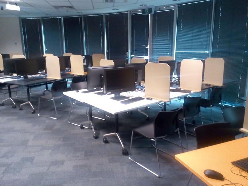 Room in the Computer Science and Information Technology Building, Australian National University, set up with temporary screens and computers for a computer based examination.  Screen design  by Bob Edwards. Photo by Tom Worthington