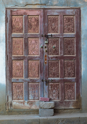 abandoned arabesque arabia arabianpeninsula arabic arabicstyle architecture buildingentrance buildingexterior builtstructure carved carvingcraftproduct colorimage cultures day dhofar door entrance exteriorview facade ghosttown gulfcountries history house housing mirbat moscha nopeople old oman oman18193 omani ornate outdoors sultanate thepast traveldestinations vertical weathered wood woodmaterial woodendoor dhofargovernorate om