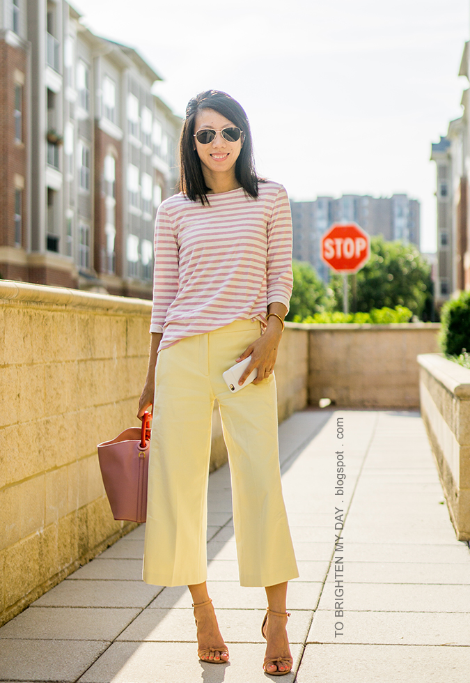 pink striped top, rose gold cuff, yellow wide leg cropped pants, pink bucket tote, brown sandals with knot