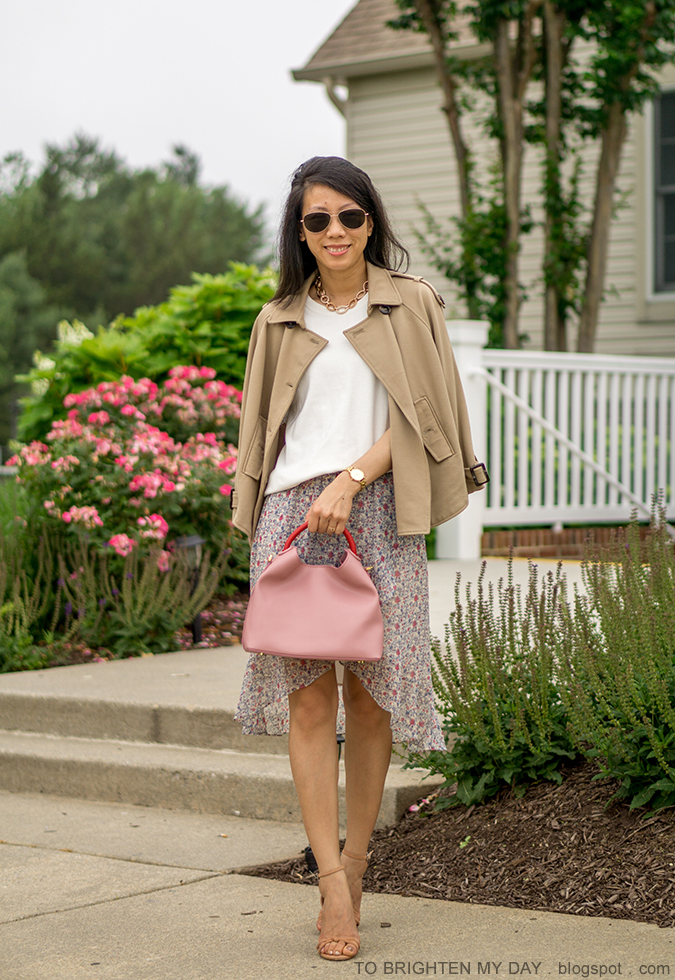 trench cape, white fringe sweater tee, gold watch, floral wrap skirt, pink tote with red handle, brown sandals with knot