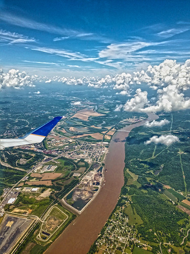airplane view window seat up sky flying river clouds distant