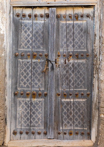 abandoned arabesque arabia arabianpeninsula arabic arabicstyle architecture buildingentrance buildingexterior builtstructure carved carvingcraftproduct colorimage cultures day dhofar door entrance exteriorview facade ghosttown gulfcountries history house housing mirbat moscha nopeople old oman oman18198 omani ornate outdoors sultanate thepast traveldestinations vertical weathered wood woodmaterial woodendoor dhofargovernorate om