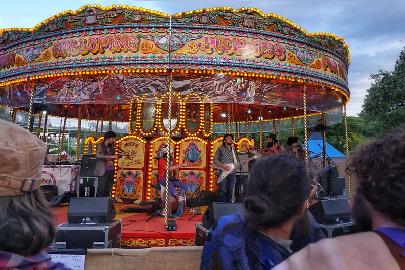 A band performs on a carousel at Wilderness Festival