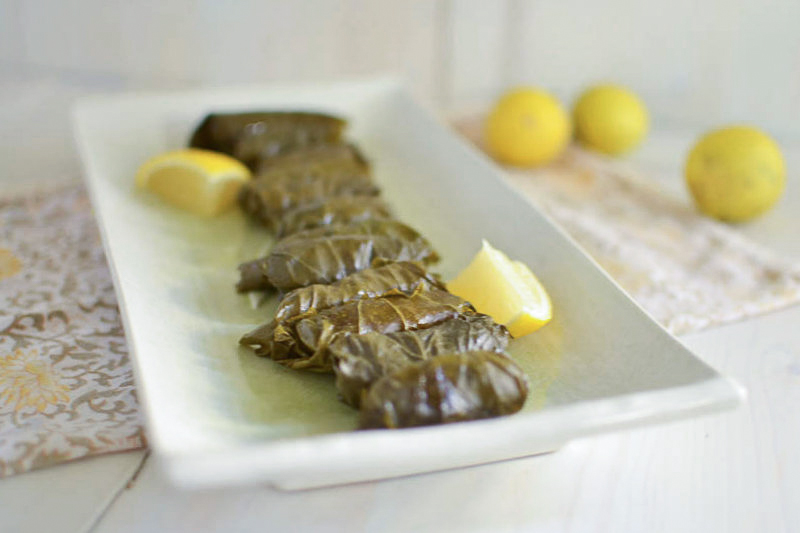A step by step guide on making my mom's Turkish stuffed grape leaves recipe . Simply filled with rice, ground beef and layered with fresh lemon.