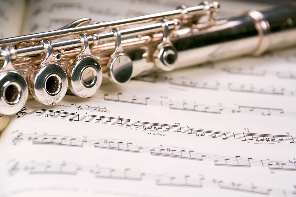 flute lying on a music score