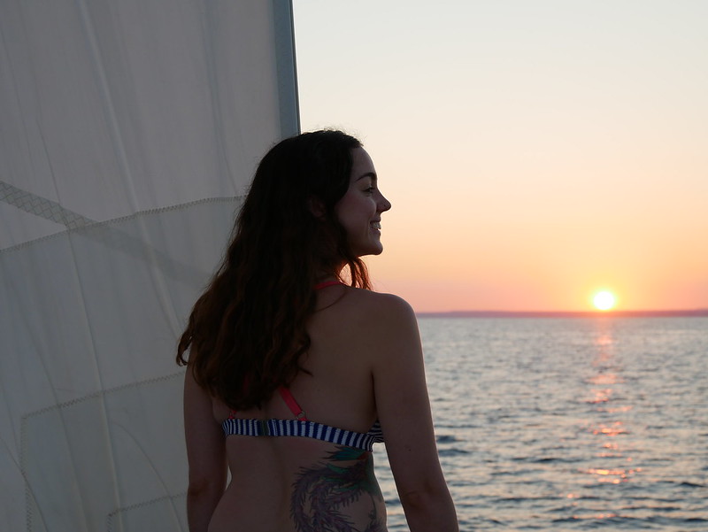 A girl in profile against a sunset at sea