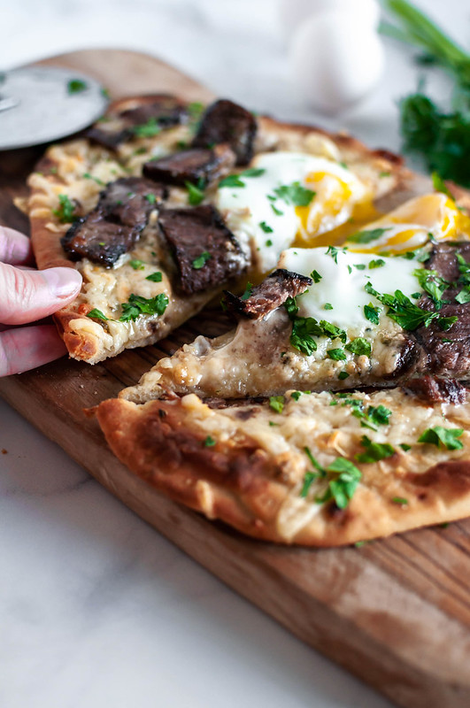 You no longer need an excuse to eat pizza for breakfast with this Steak and Egg Flatbread Pizza. Two cheese, juicy, marinated steak and a drippy egg combine into the ultimate breakfast, lunch or dinner pizza.