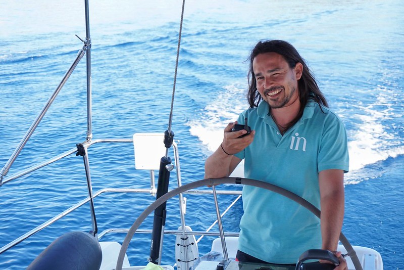 Captain Pau winks at the helm of his InAdventures boat in Mallorca