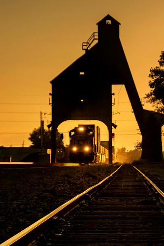 coalingtower coalstation coalstage vintage relic history historic silhouette sunset evening goldenhour dekalbillinois uprr unionpacificrailroad genevasubdivision tracks backlight freighttrain stacktrain unittrain eastbound themidwest rural signals semaphores ballast framing transportation summer august dusk cofc containers locomotive headlights arches nostalgia landscape vertical chutes gravity nikond7500 sigma18300 photoshopbyfehlfarben thanksbinexo