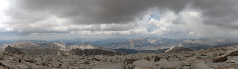 Panorama view to the west from the summit of Mount Whitney as the clouds above us get darker