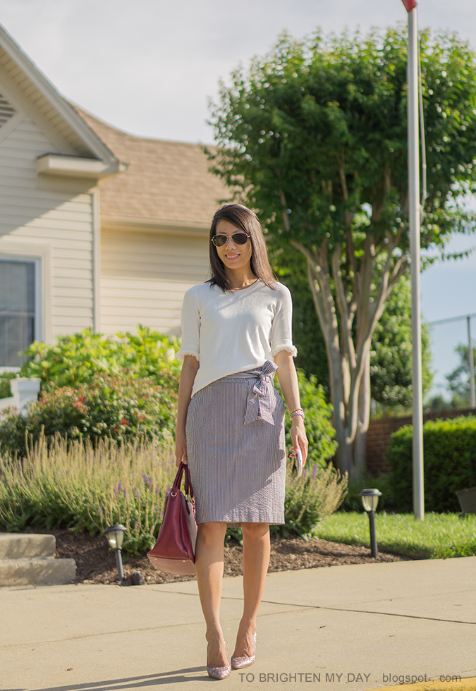 white sweater with fringe, blue striped seersucker pencil skirt with bow tie, two tone watch, rose gold cuff, morganite ring, burgundy red tote, rose gold glitter pumps