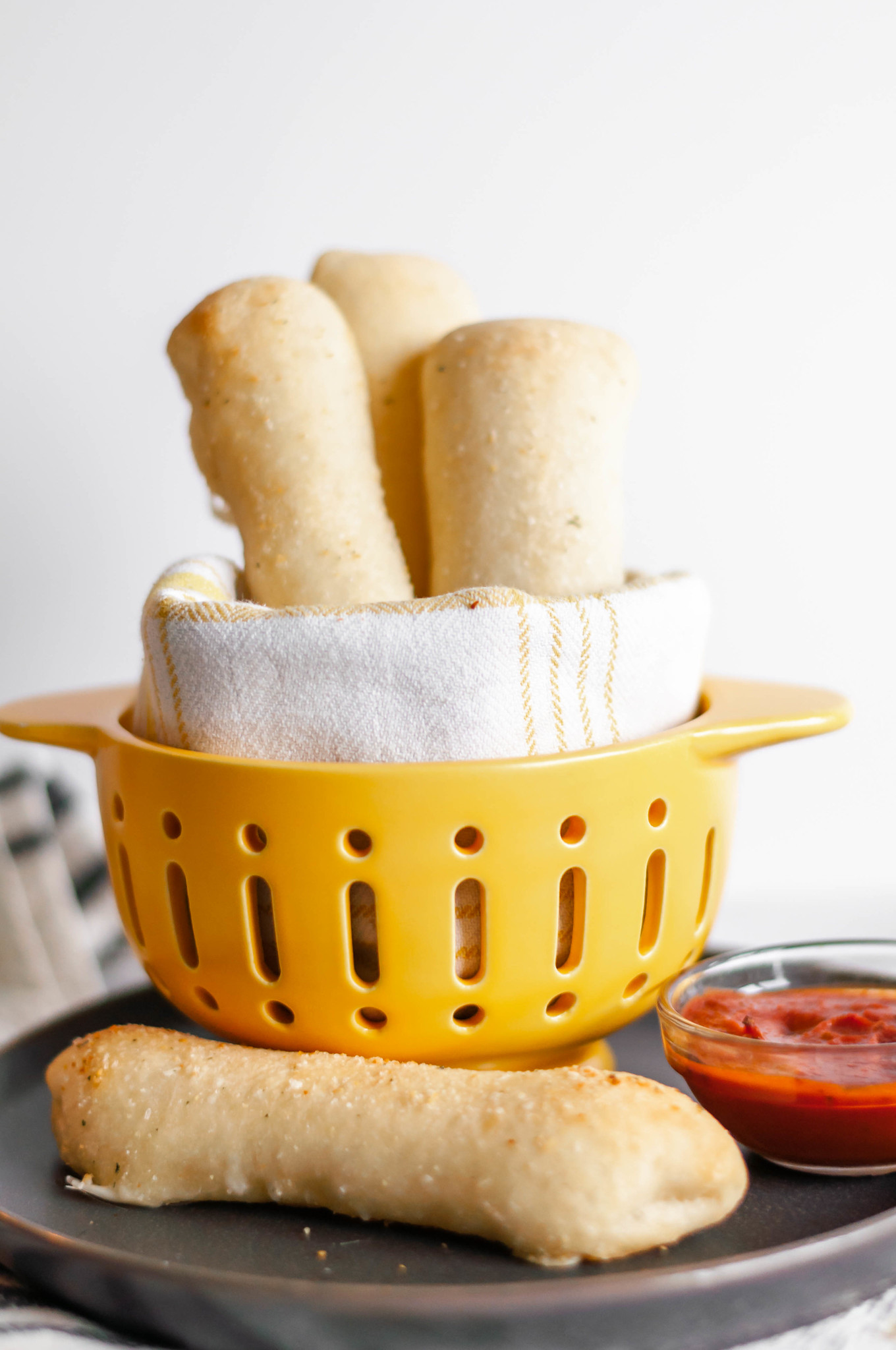 Cheese Stuffed Breadsticks are super simple, 4 ingredient perfection. Pizza dough, string cheese, butter and garlic salt are all you need for this cheesy, carb deliciousness.