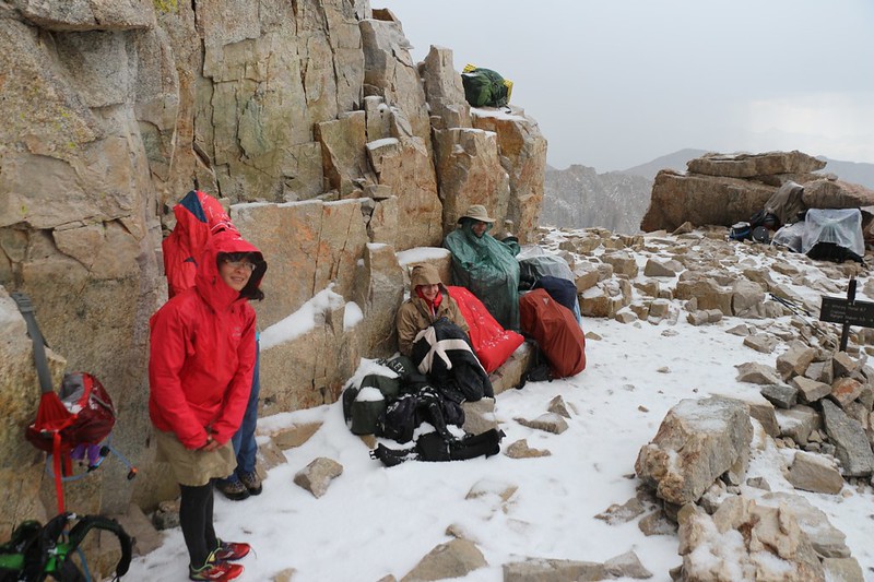 Several other hikers at Trail Crest, some hunkering down, are thinking about heading down to Whitney Portal