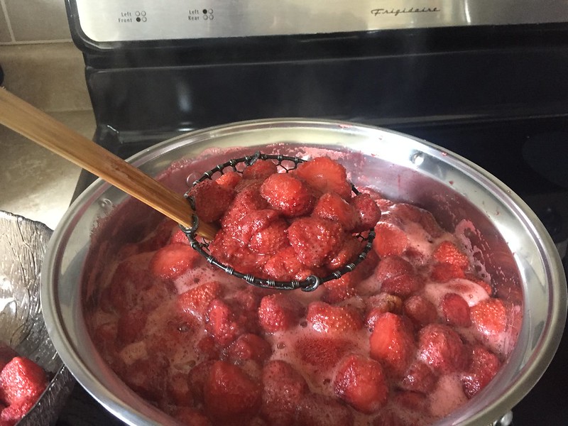 straining the strawberries