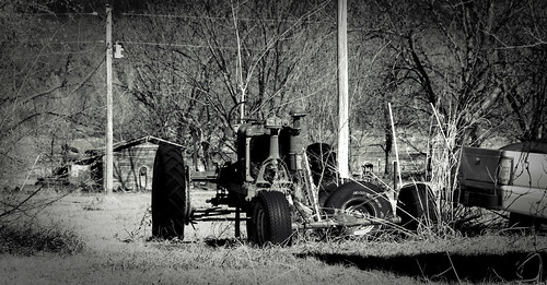 monochrome junk utilitypoles shadows tires baretrees abandonedhouse abandonedvehicle rust blackandwhite weathered pickuptruck