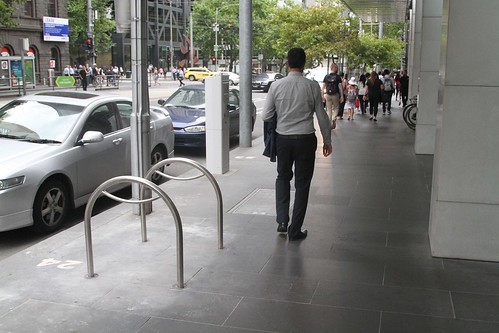 Bike racks running 90 degrees to the road and blocking the footpath at William and Bourke Street
