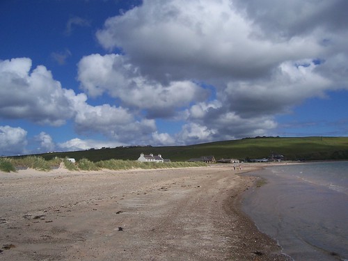 scapa beach orkney islands clouds sand sea houses dunes water grey weather blue sky warm sunshine low view allanmaciver