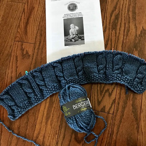 Another baby knit is on my needles - Heirloom Cables Baby Sweater that I am knitting in one piece with Bergere de France Alaska