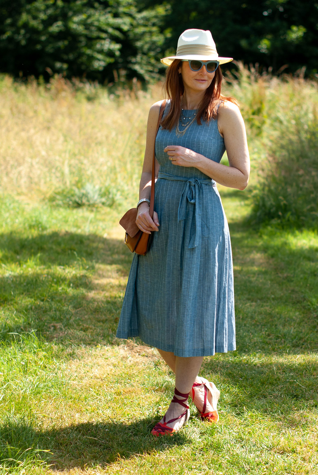 A Lightweight Chambray Dress Perfect for Summer \ styled with a cream Panama hat, tan crossbody bag, red wedge espadrilles and blue cat eye sunglasses | Not Dressed As Lamb, over 40 fashion