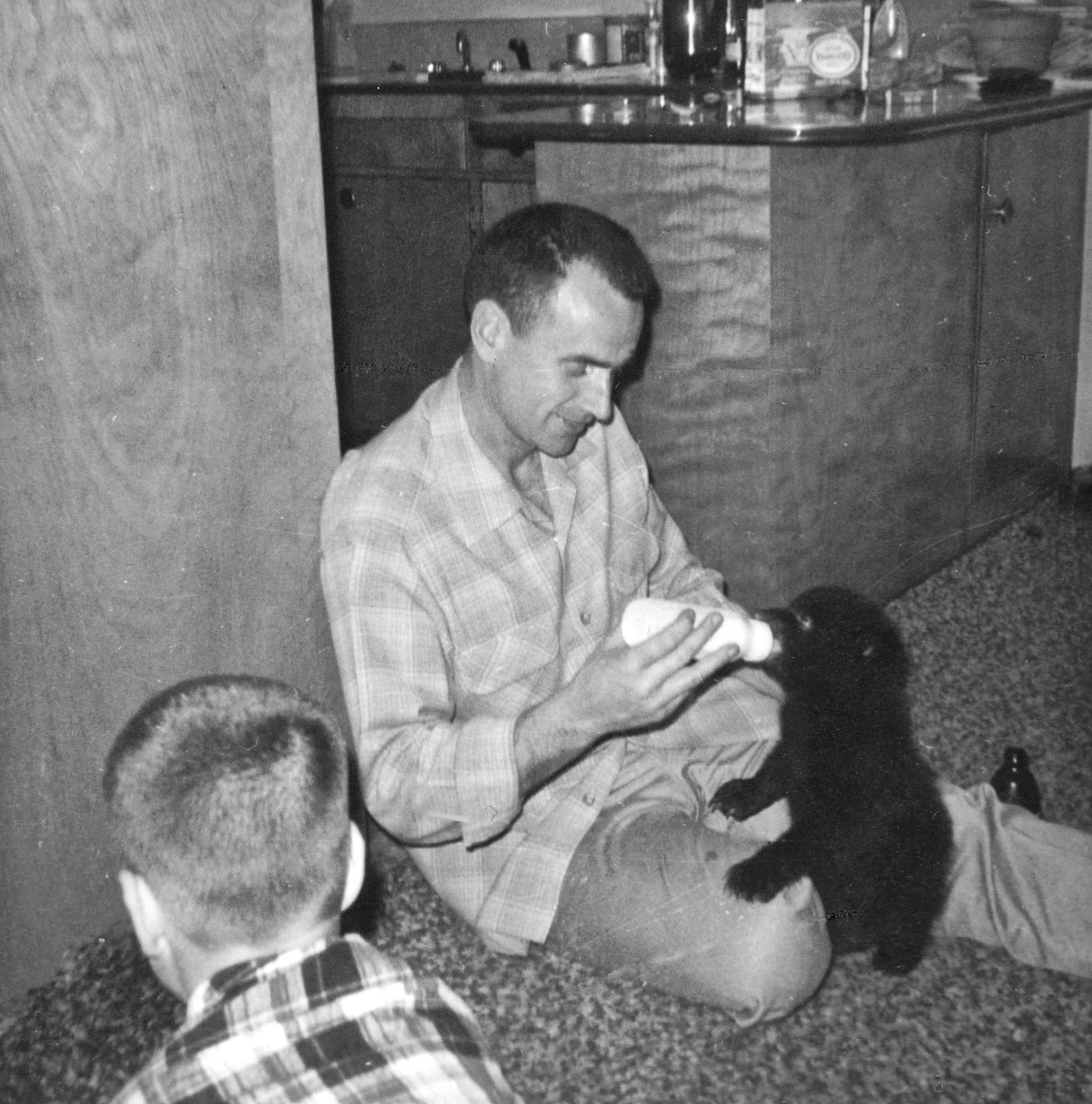 My father feeding a bear cub in our home, 1965.