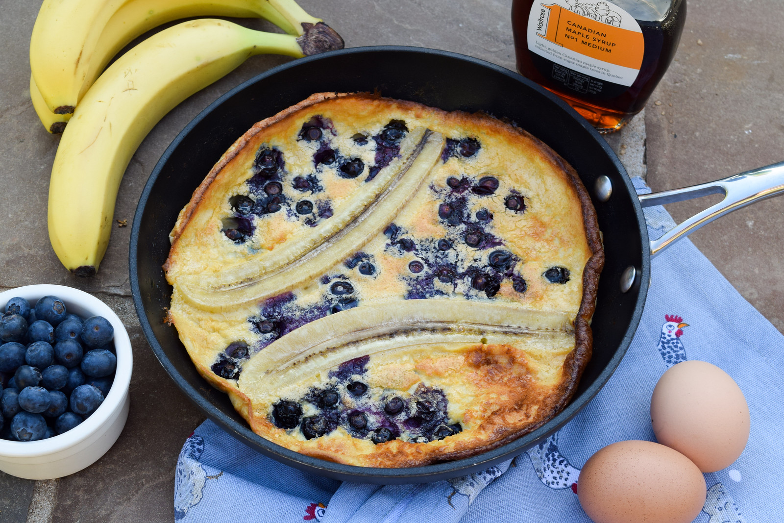 Banana and Blueberry Dutch Baby Pancake with Maple Syrup