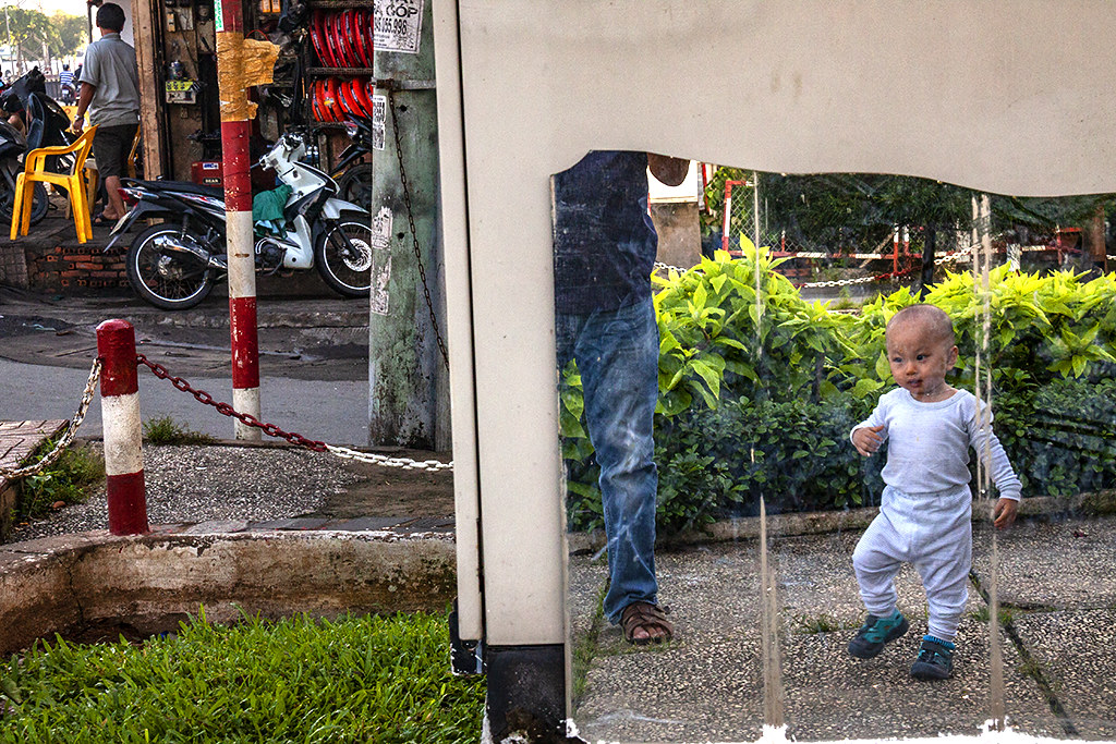 Suki in mirror at park--Saigon