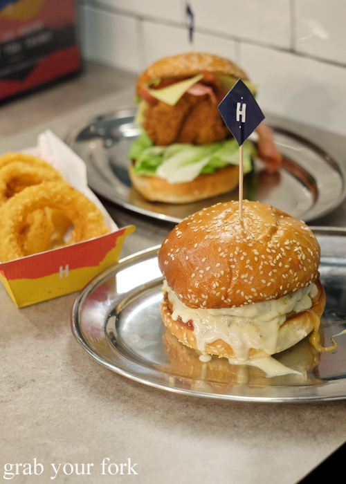 Cheesus beef burger, the Britney chicken burger and onion rings at Huxtaburger in Redfern Sydney