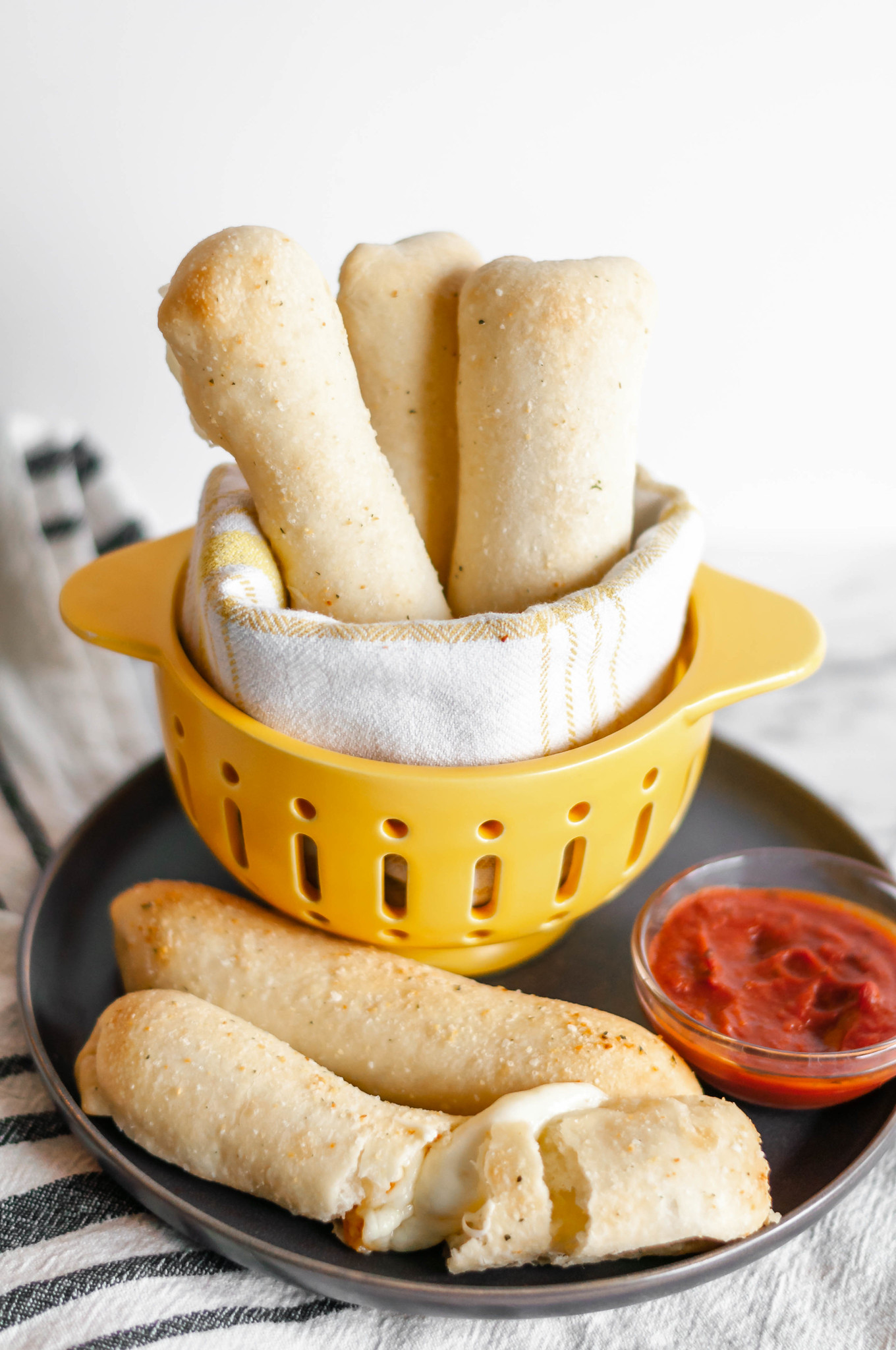 Cheese Stuffed Breadsticks are super simple, 4 ingredient perfection. Pizza dough, string cheese, butter and garlic salt are all you need for this cheesy, carb deliciousness.