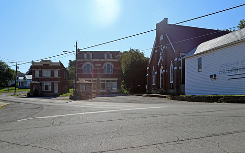 mayslick kentucky masoncounty buildings structures historic downtown village intersection building structure commercial romanesque turnofthecentury gothicrevival church brick stringcourses storefronts street cables wires trees buttresses roundarched windows bank