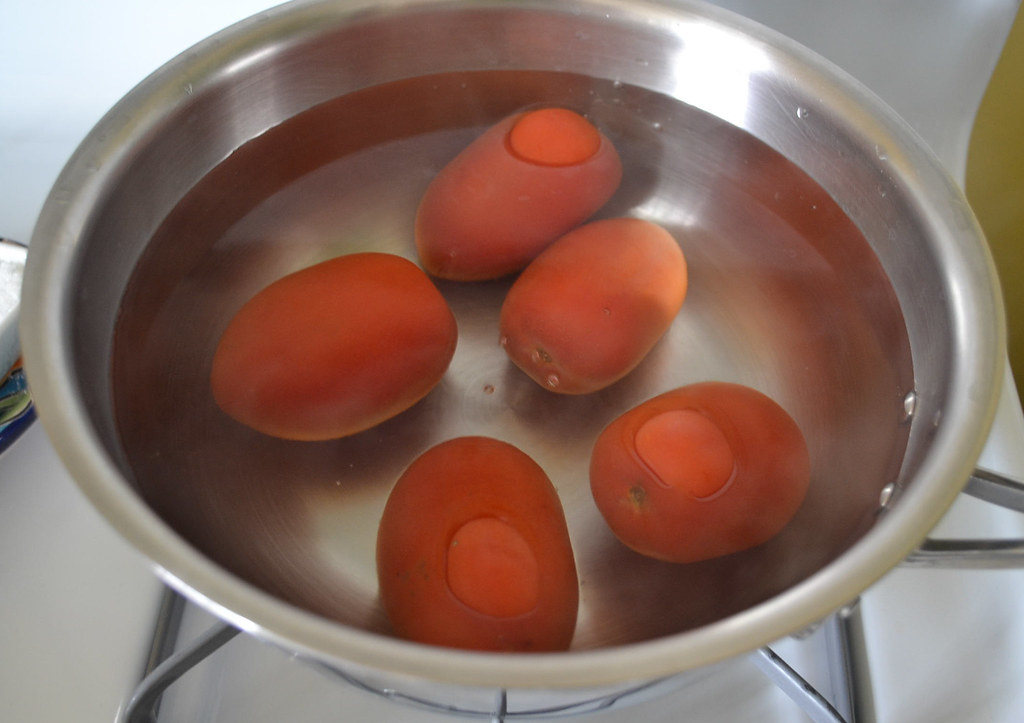 Blanch cook the tomatoes to easily remove the skin for ratatouille.
