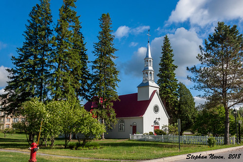 mont tremblant alpine church chapelle saintbernard canada quebec tree blue sky red white bell tower outside landscape mountain