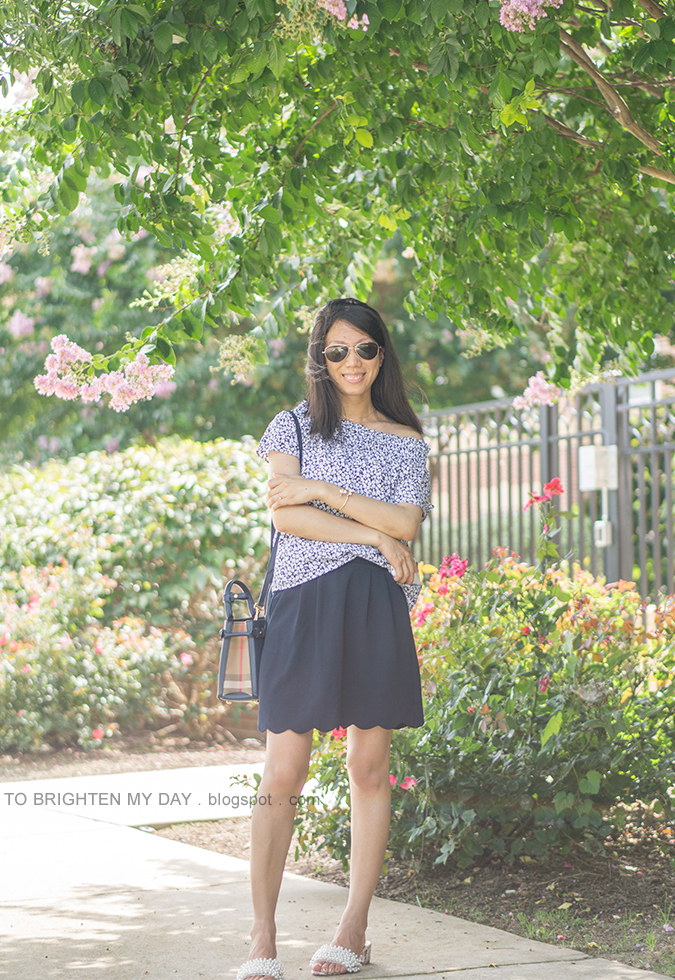 off the shoulder floral top worn on one shoulder, blue plaid tote, navy scallop skirt, white floral cuff, pearl embellished sandals